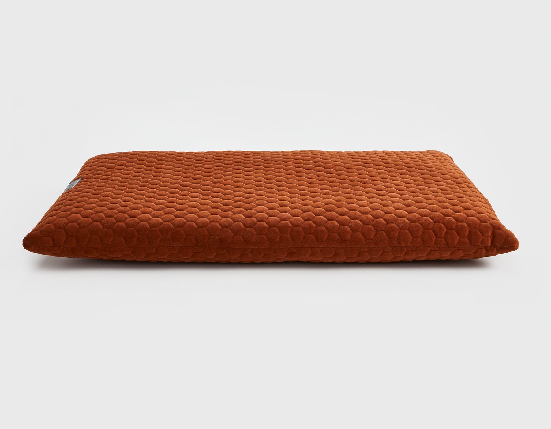 Brown textured decor friendly dog cushion on a white background