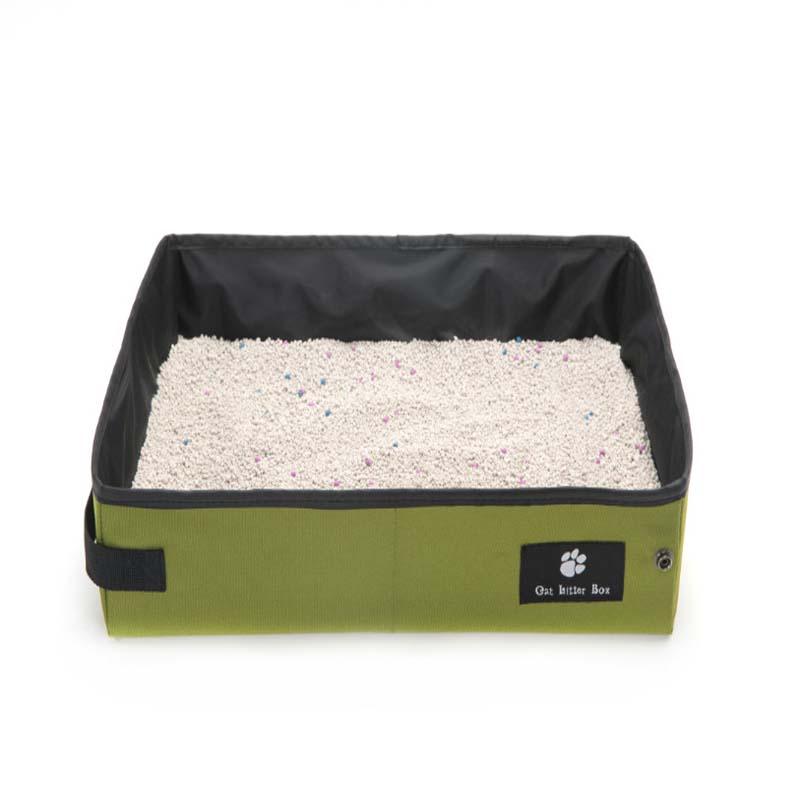 Portable cat litter box with green base and black lid on a white background
