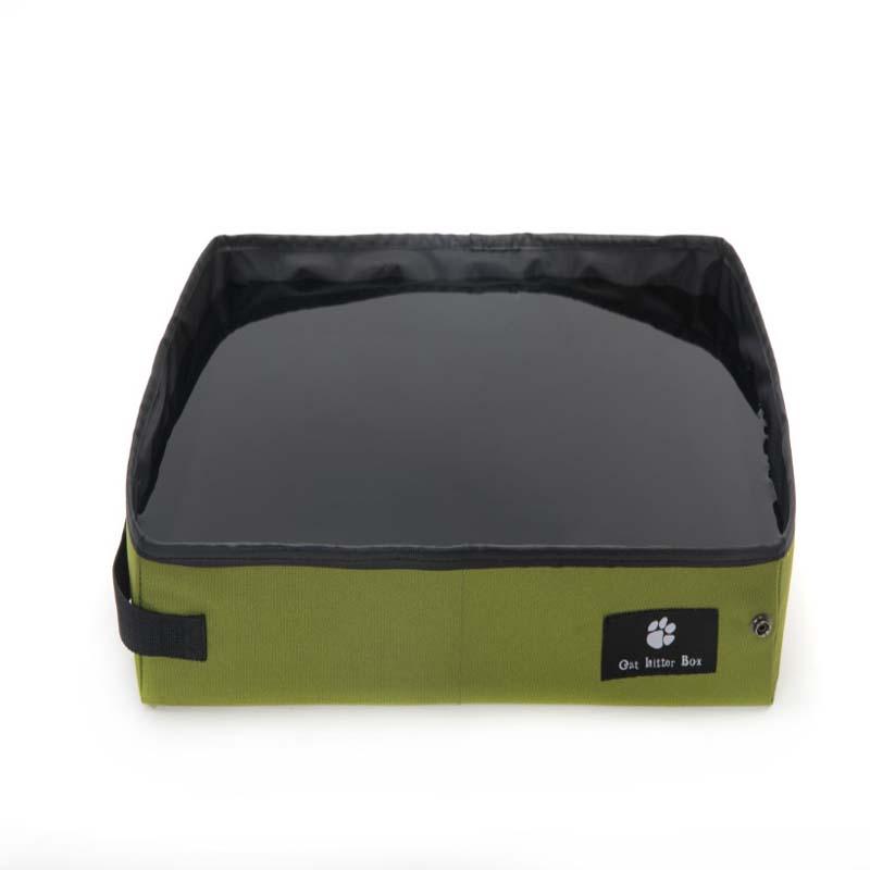 Green and black cat litter box for travel with a visible brand label on a white background