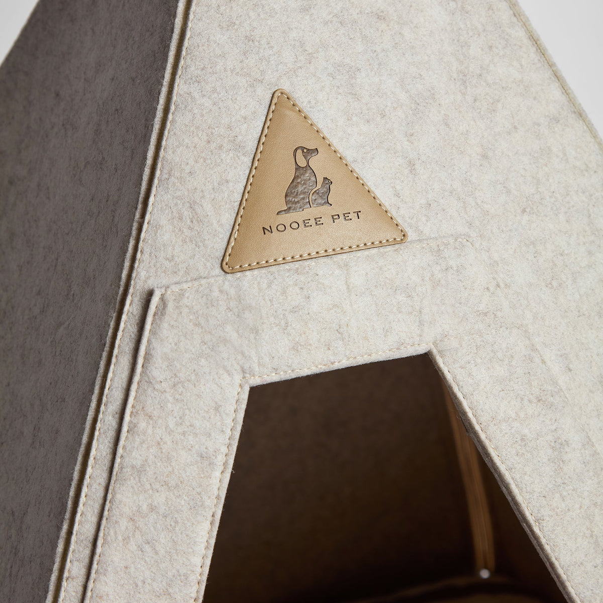 Close-up of the Nooee Pet teepee bed opening and leather logo patch