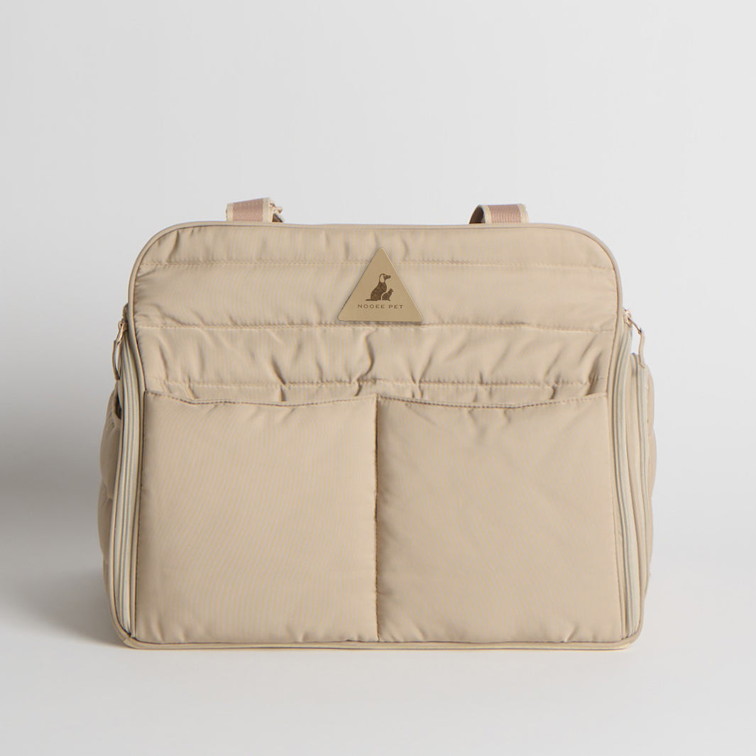 Beige pet carrier for small dogs with a brand logo on a light gray background