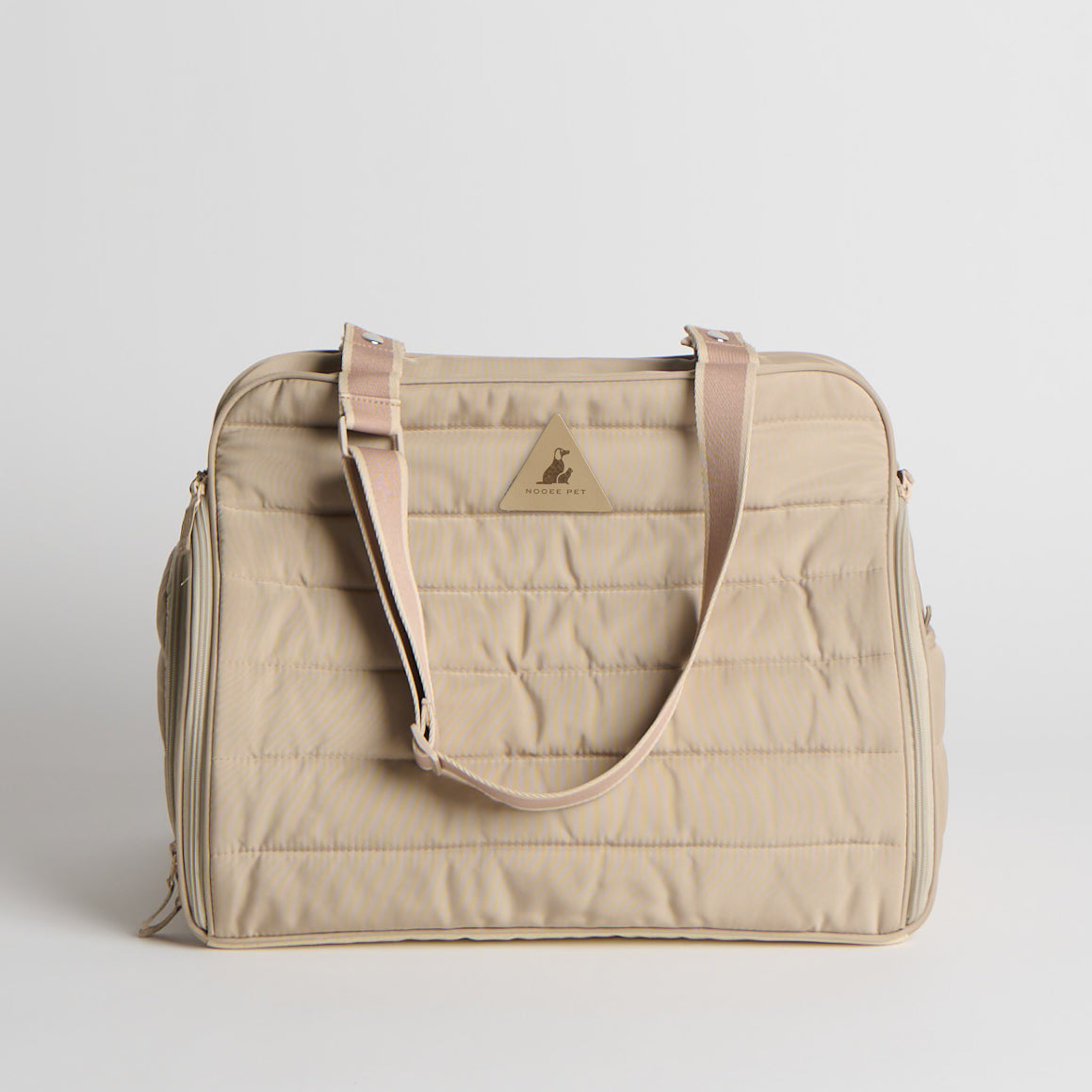 Beige travel bag with a visible brand logo on a light gray background