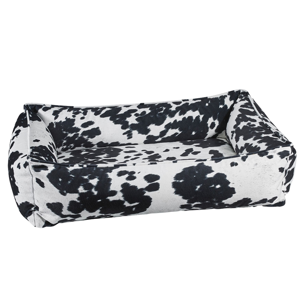 Modern orthopedic cowhide print dog bed with a streamlined one-piece design and luxury microvelvet washable fabric cover.