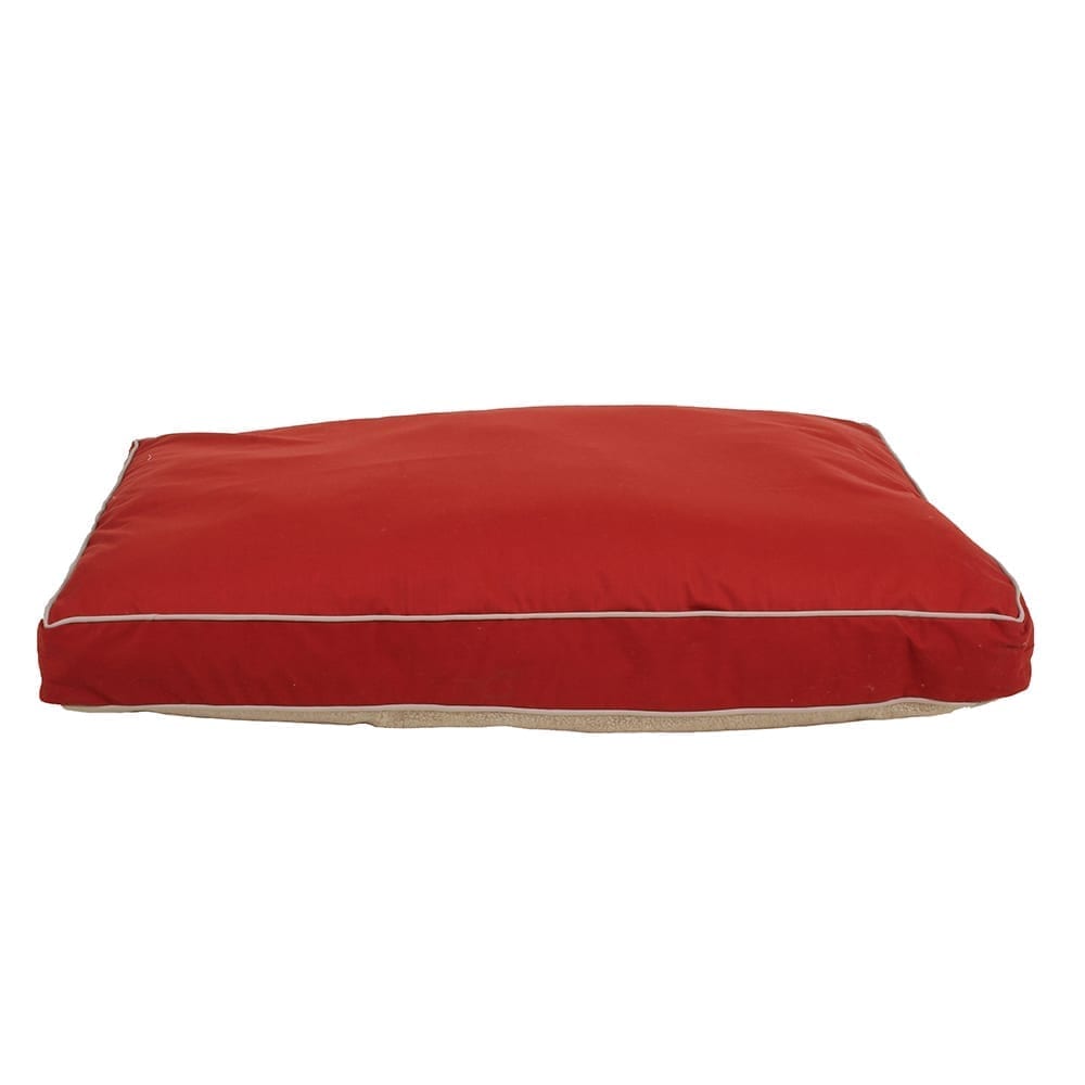 Red pet bed with white trim on a white background