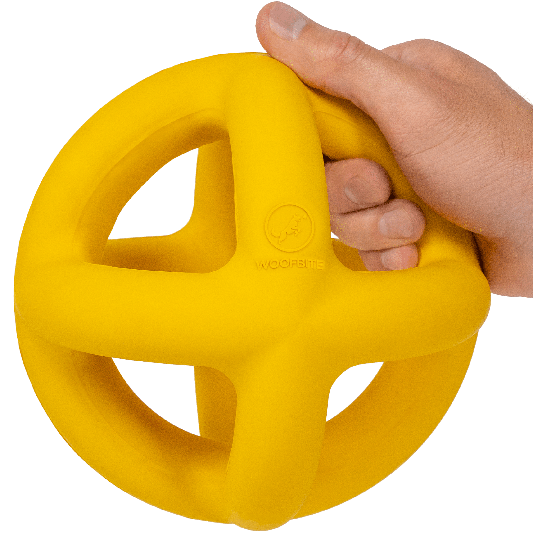 Hand holding a yellow indestructible dog ball with a white background