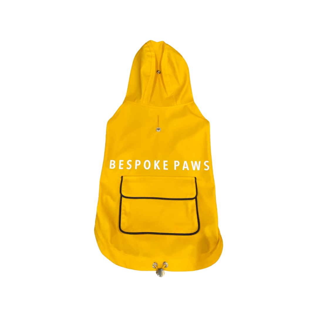 Yellow dog raincoat with 'Bespoke Paws' branding on a white background