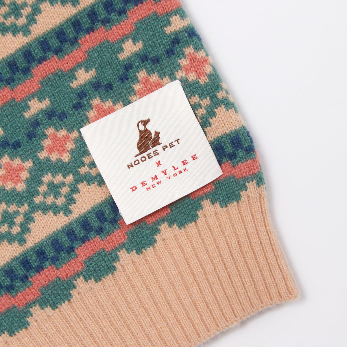 Close-up of the jacquard knit pattern and Nooee Pet x DEMYLEE label
