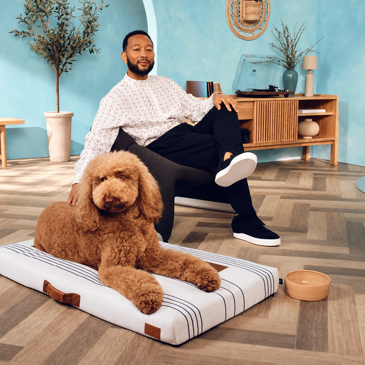 John Legend and his dog posing with his dog bed design