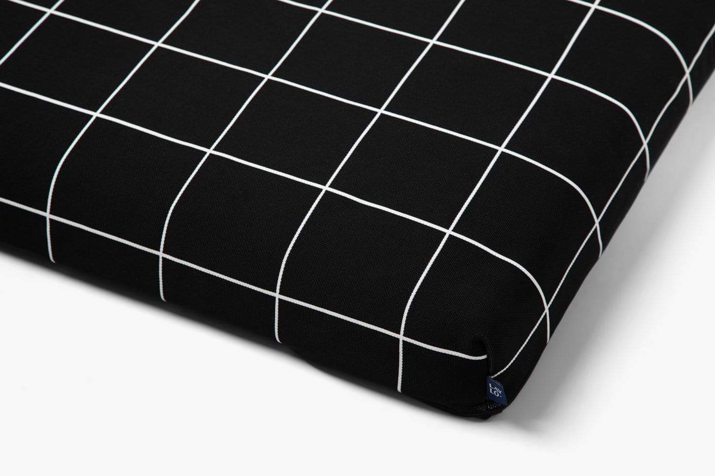 Black dog mattress cover with white grid pattern on a light gray background