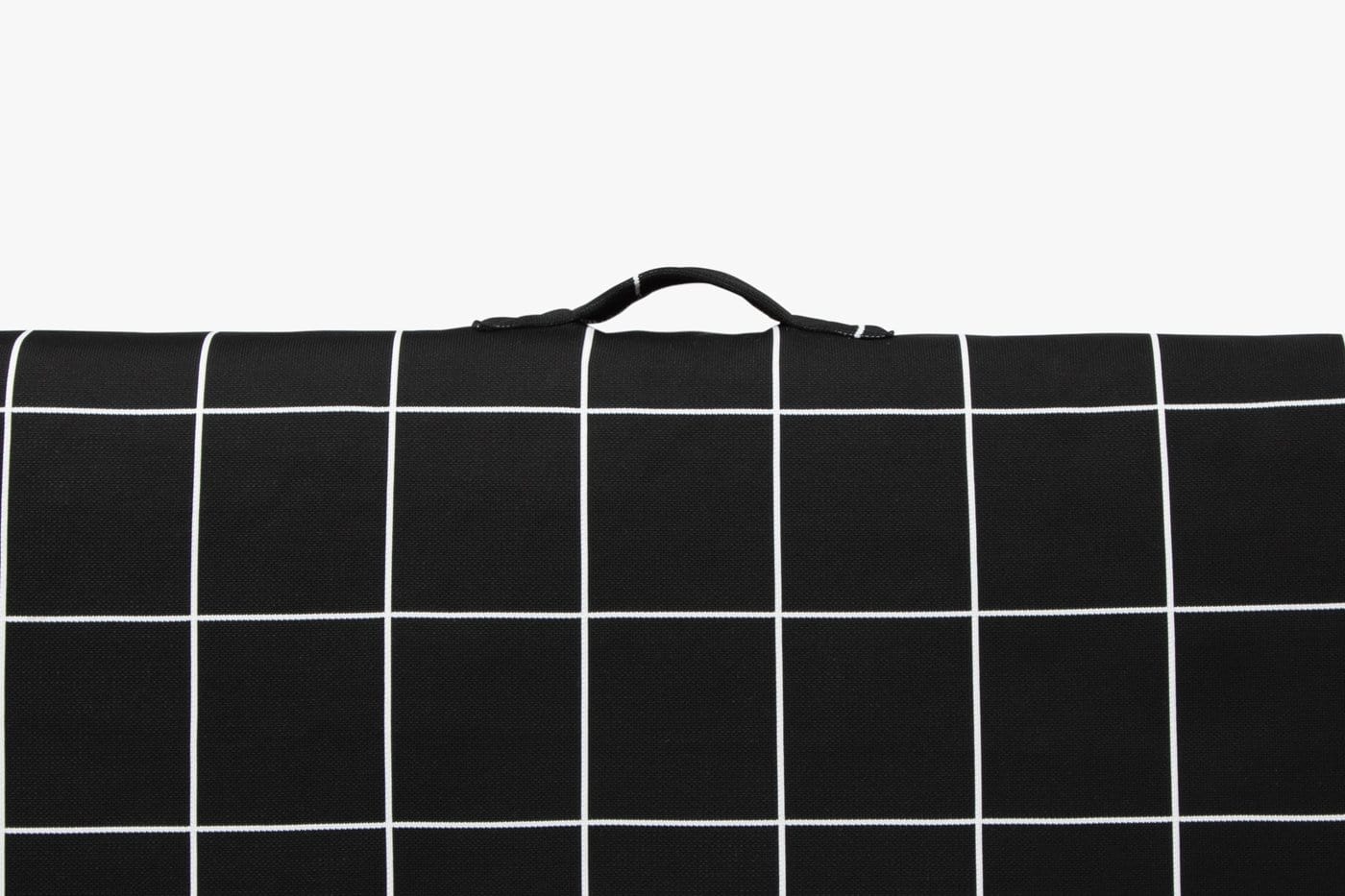 Black checkered dog mat with a vegan handle on a white background