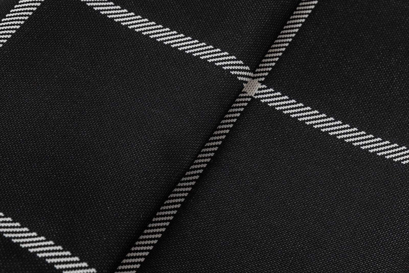 Close-up of black dog bed cover fabric with white diagonal stripes by Lay Lo