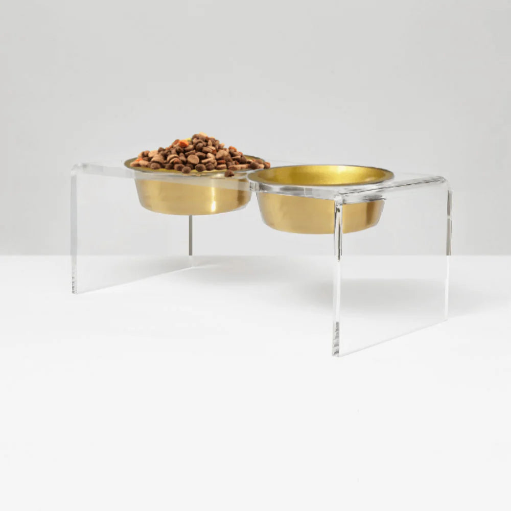medium size gold stainless steel pet bowls on a clear stand with white background
