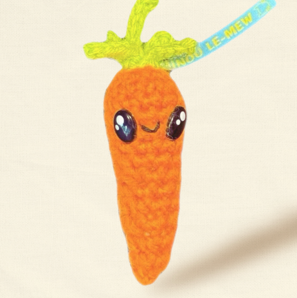 Carrot-shaped plush toy with a smiling face on a beige background