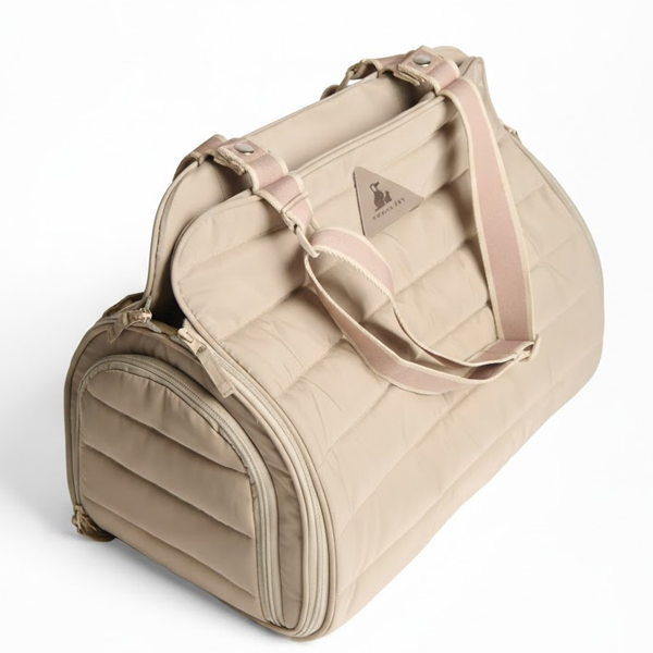 Beige pet carrier by Nooee with pink handle on a white background