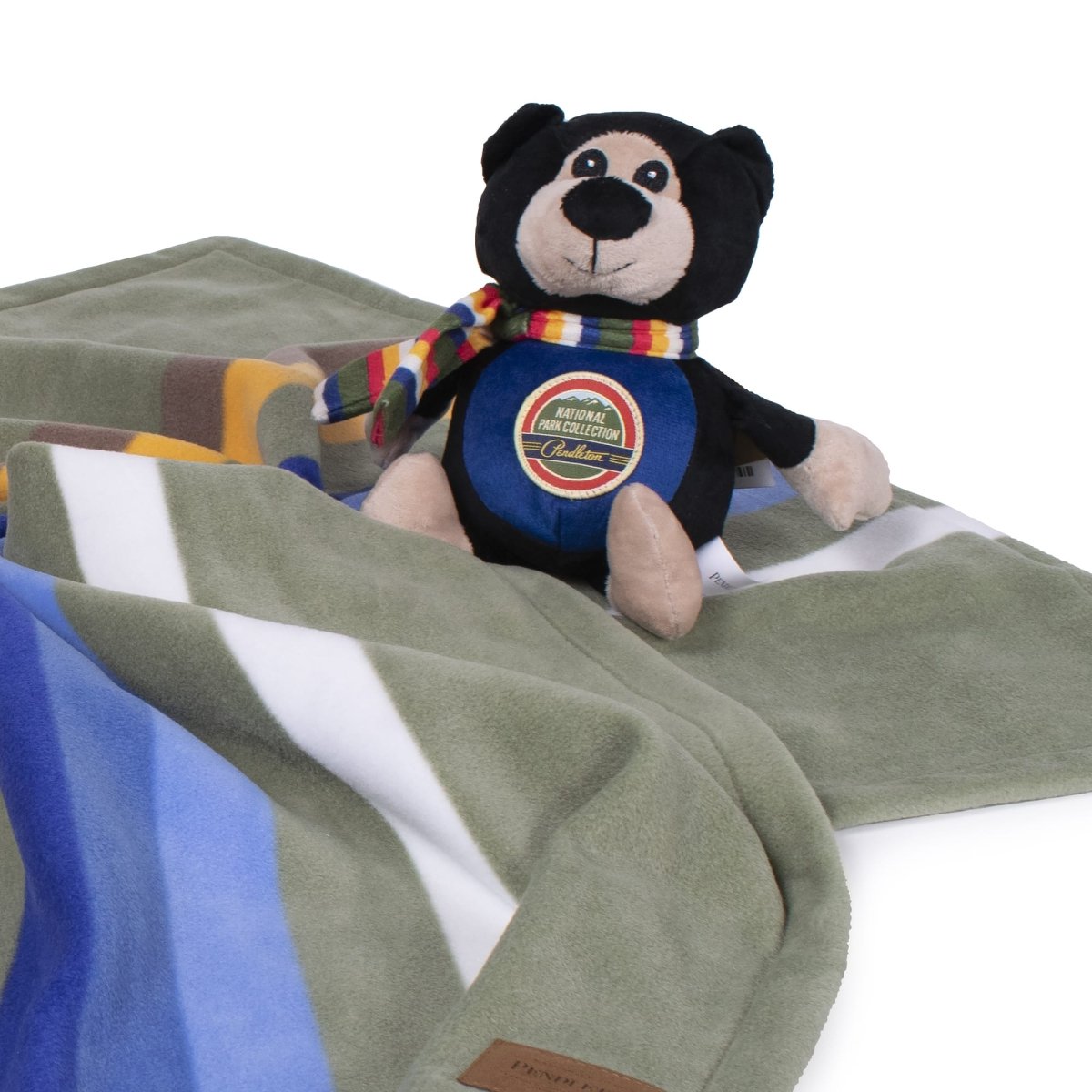 Pendleton National Park Pal bear toy on a green Pendleton pet blanket
