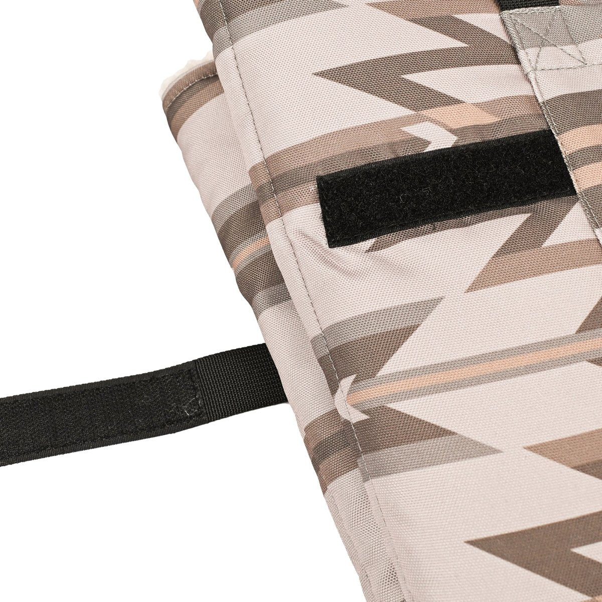 Close-up of a patterned bag with a black strap on a white background