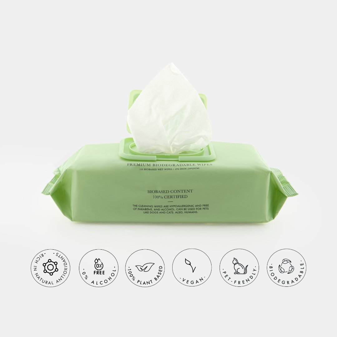 Green packaging of biodegradable pet wipes with icons indicating product features on a white background