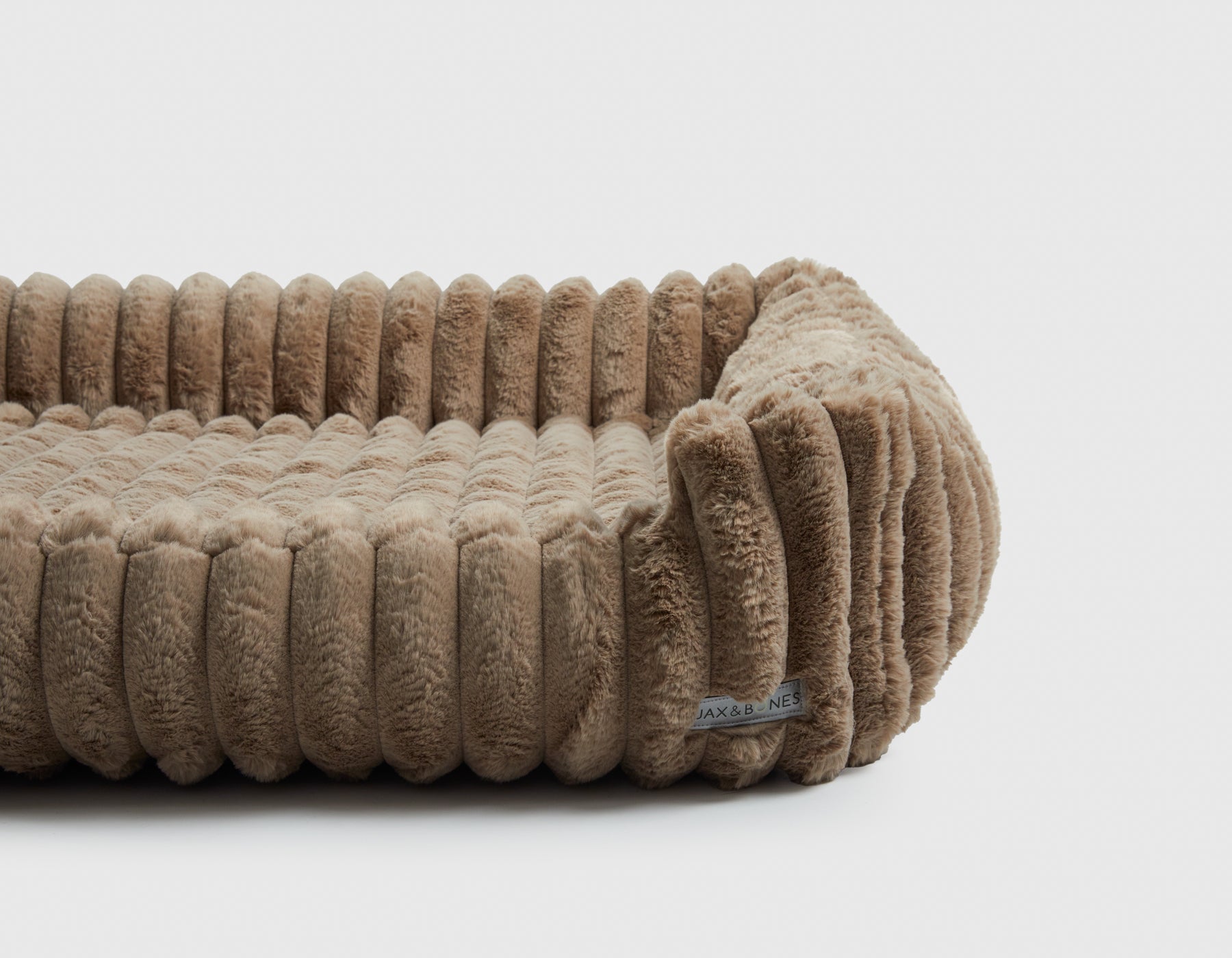 Beige textured large dog bed on a white background