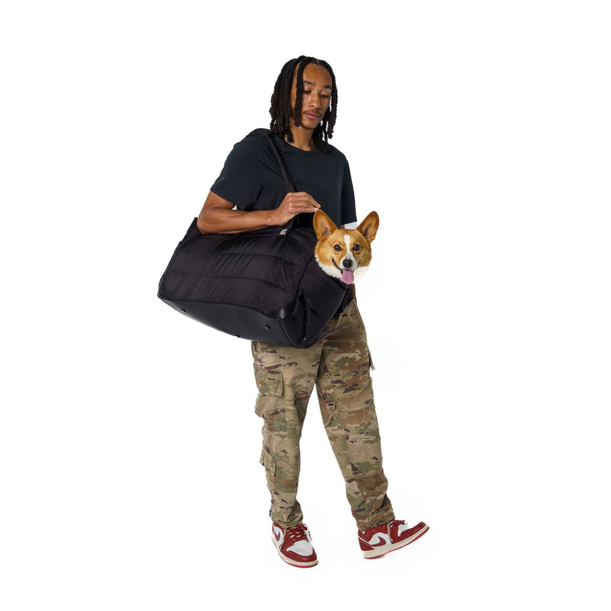 Man carrying a corgi in the large Subway Tote over his shoulder