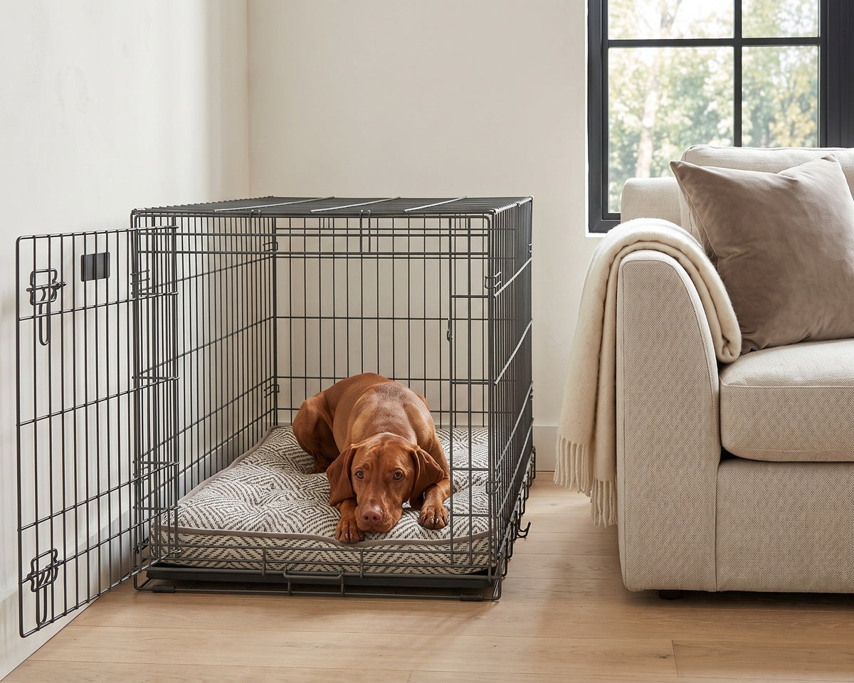 Vizsla resting on the Bowsers Luxury Dog Crate Mattress in Diamondback inside a wire crate