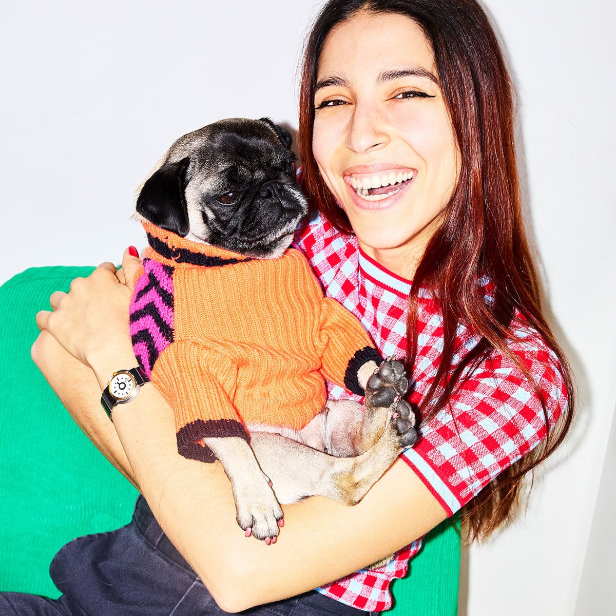 Woman hugging a pug wearing the Lil Baddie dog sweater in Orange Crush