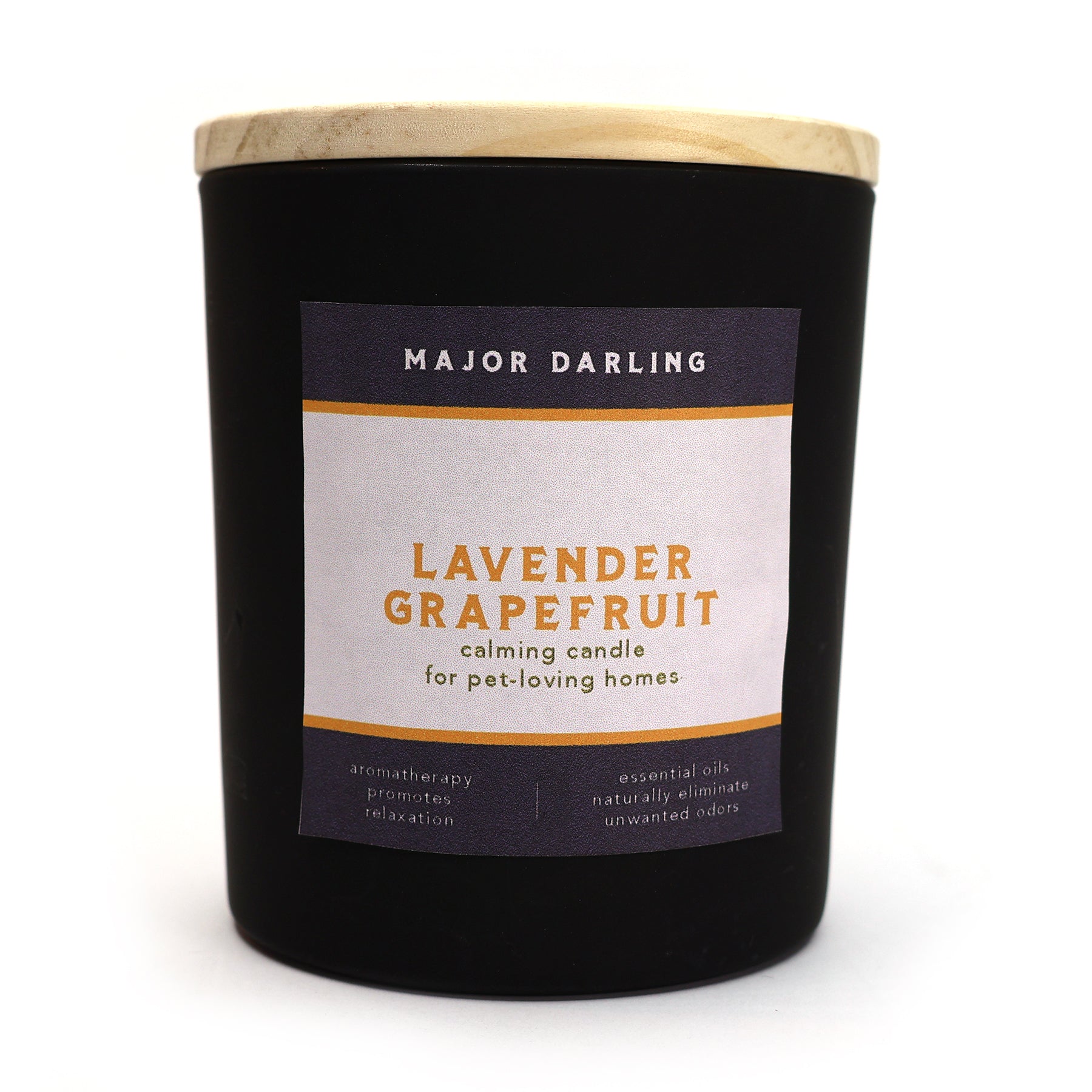 A black candle with a wooden lid and a label that reads 'Lavender Grapefruit calming candle for pet-loving homes'. The candle is scented with lavender and grapefruit and is made with soy and coconut wax.