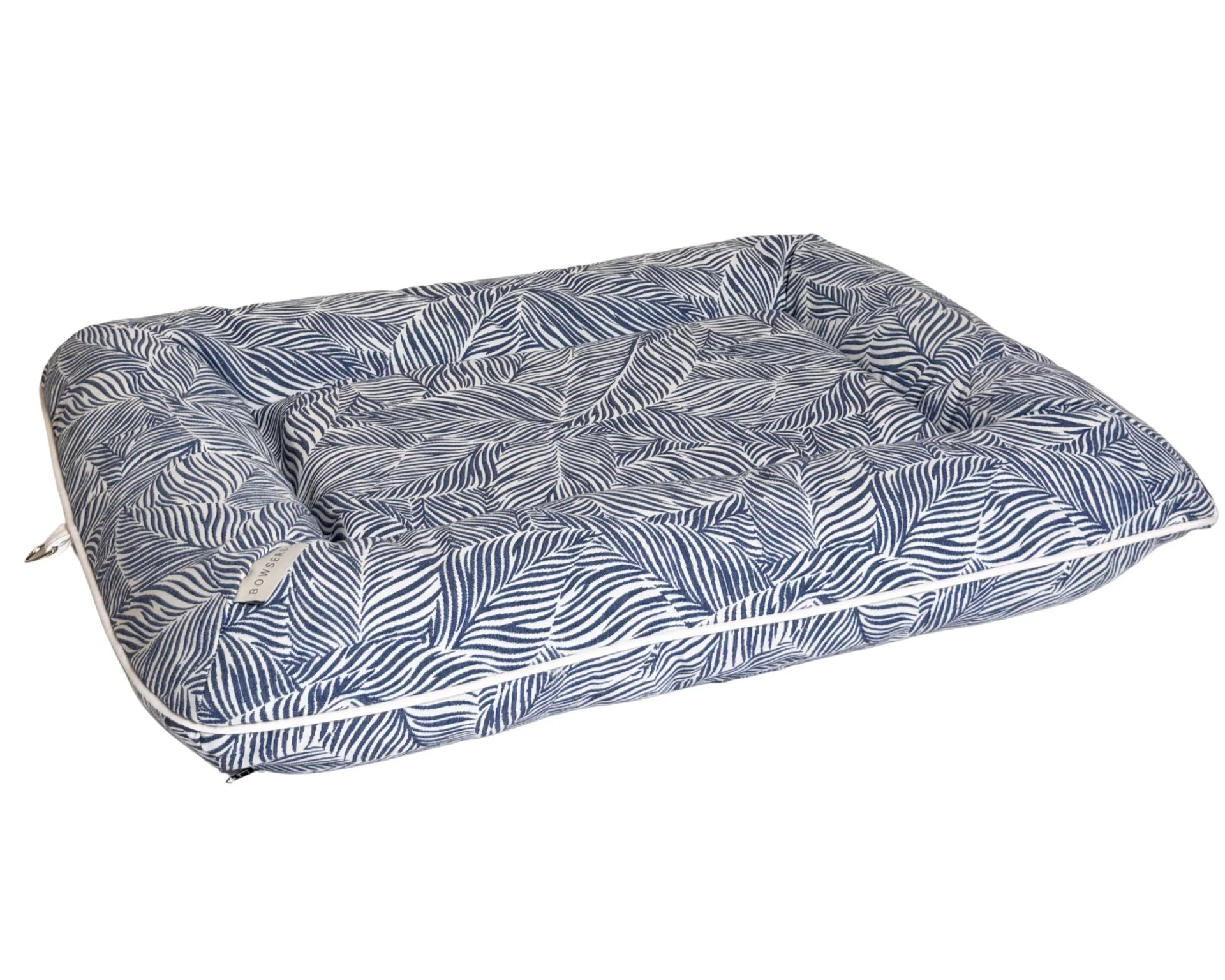 A rectangular outdoor pet bed with a raised center, featuring a blue and white palm leaf pattern, shown on a plain white background.