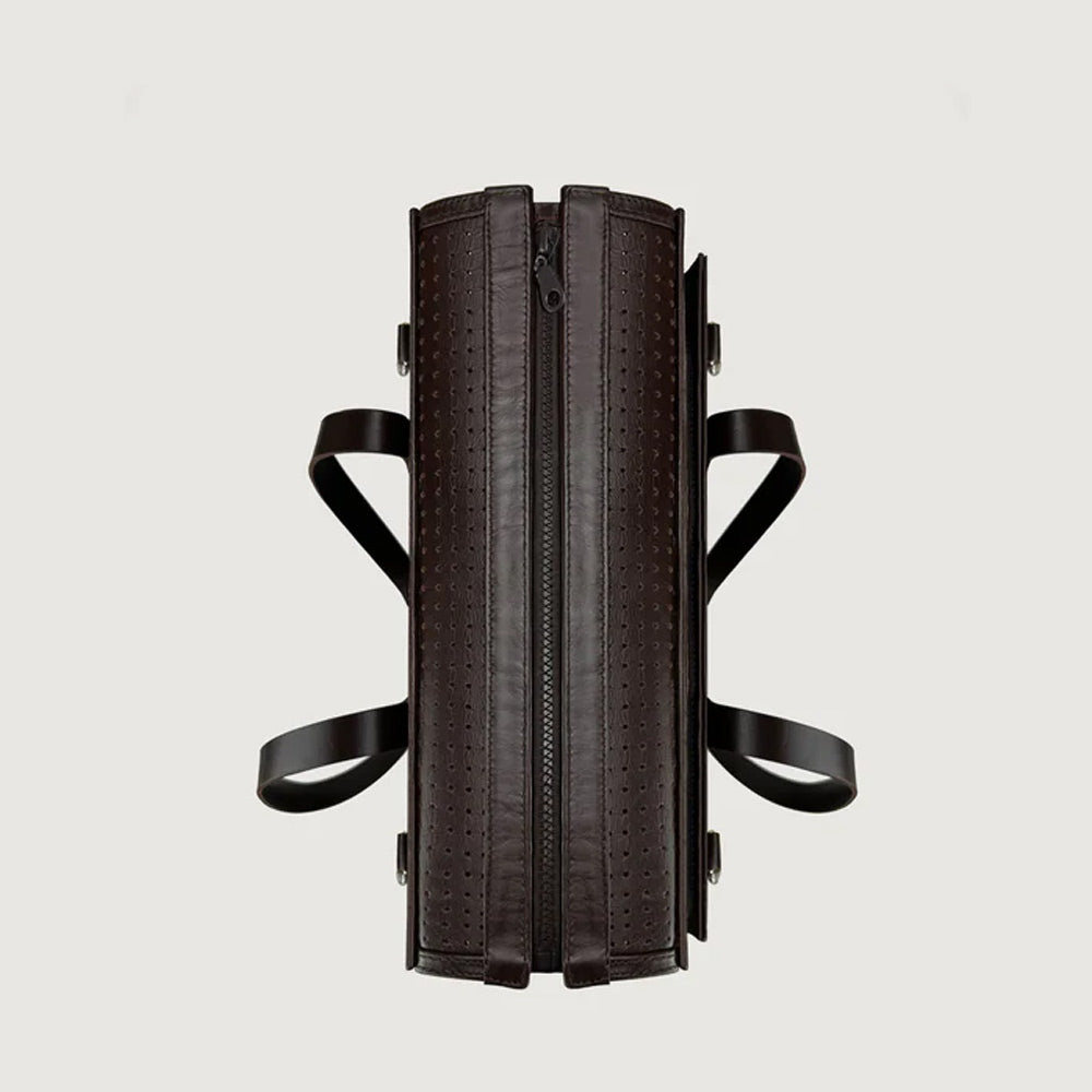 Black leather dog bag with straps on a light gray background