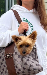 Fashionable girl carrying her dog in bowsers designer dog carrier shoulder bag