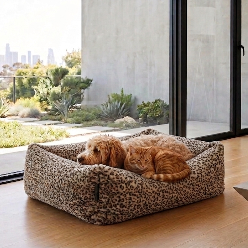 Dog and cat lying on a leopard print pet bed in a modern indoor home decor.