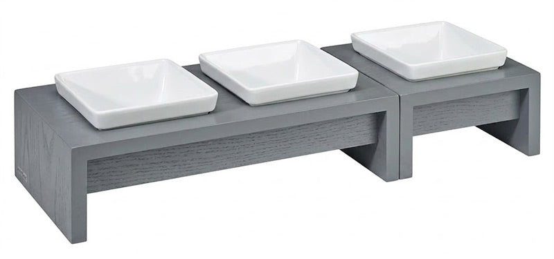 Modern grey wood stand holding three white square ceramic pet bowls by Bowsers