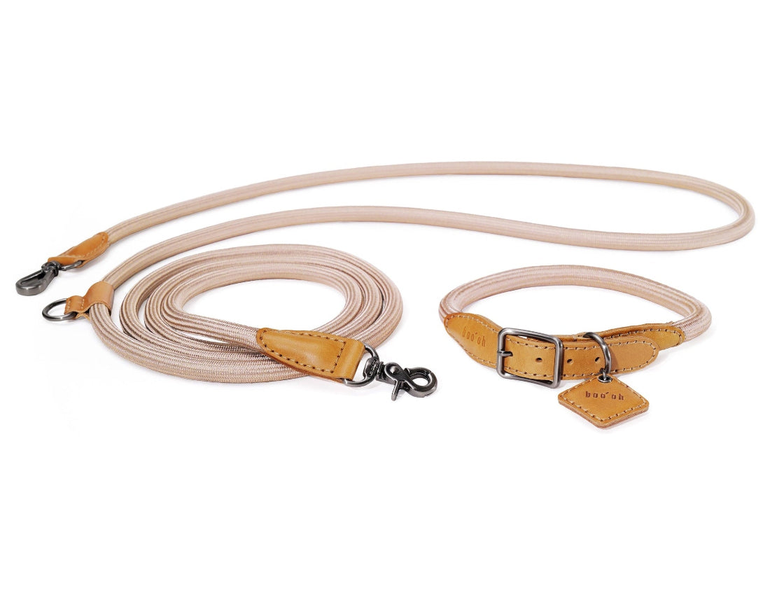 Dog leash and collar set with beige leather and metal hardware on a white background with boo oh logo