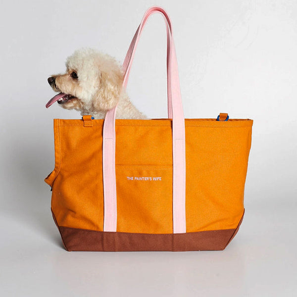 Small dog inside a cotton canvas dog tote.