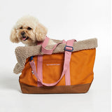 medium size dog inside a cotton canvas dog bag carrier