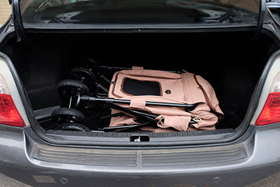 Foldable big dog stroller in a car trunk