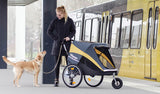 Dog mom taking the subway with her Labrador Retriever and dog stroller