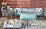 Stylish miacara outdoor dog bed with a small brown puppy inside.