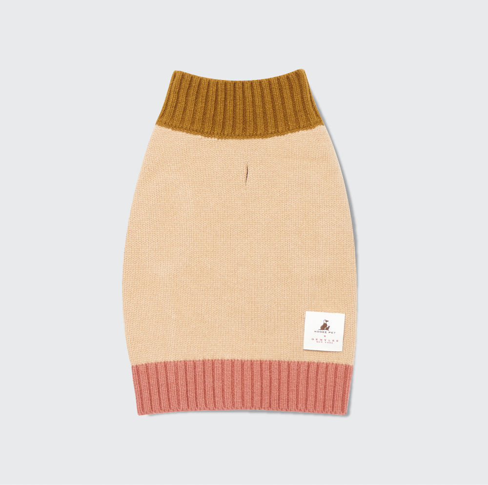 Wool dog sweater with a beige body, mustard top, and pink bottom on a light gray background