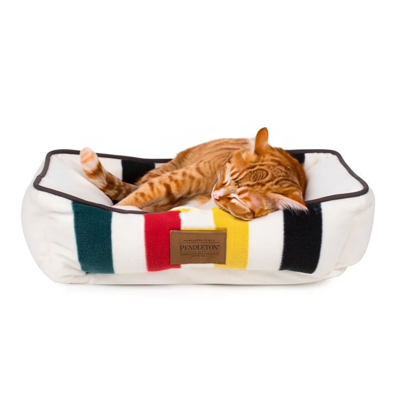 Orange cat sleeping on pendleton glacier warm kuddler bed