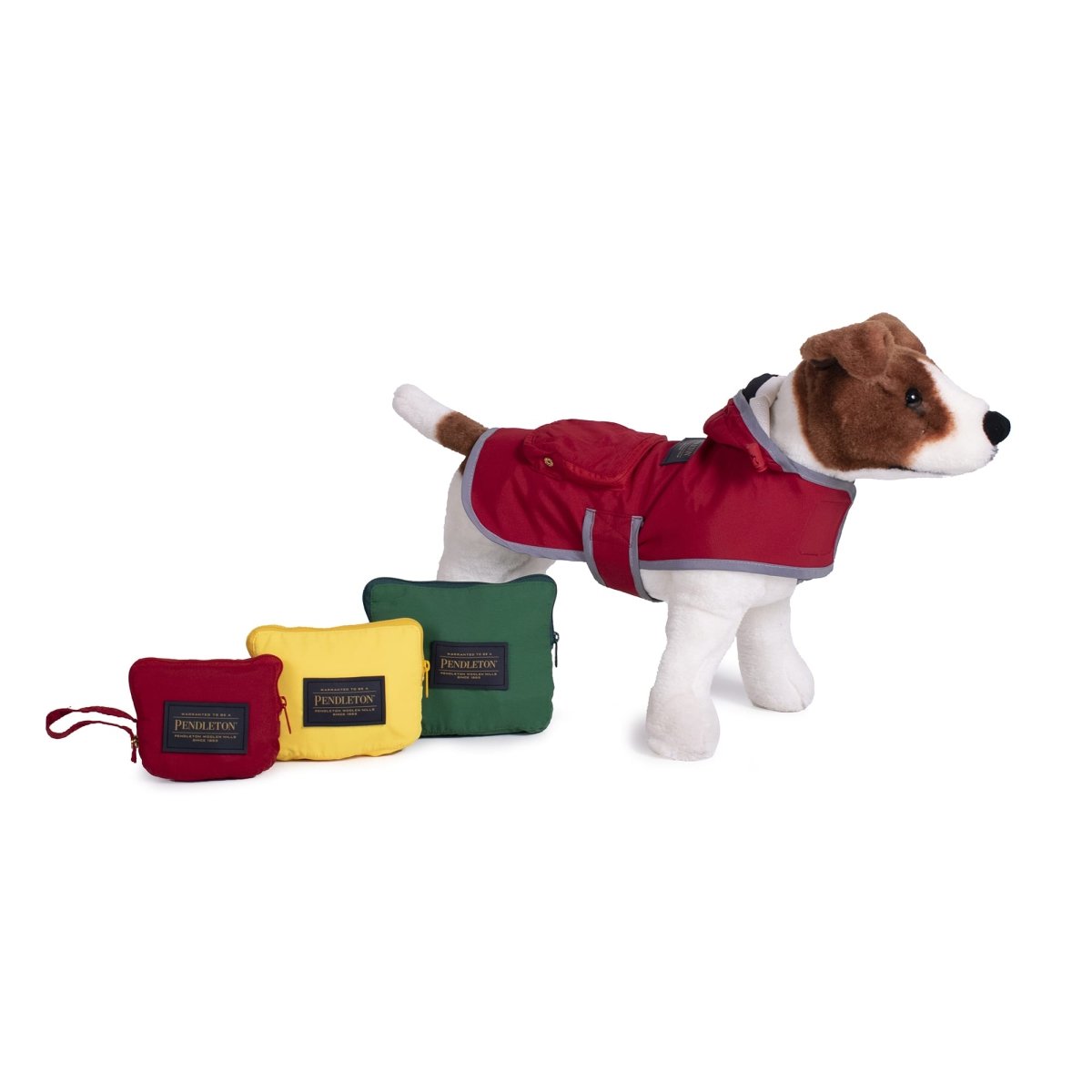 Dog wearing a red coat with three colorful Pendleton jackets on a white background