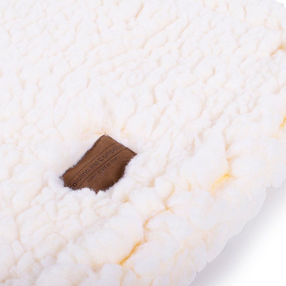 Close-up of a textured white surface with a brown label.