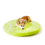 Corgi sleeping on an orthopedic dog bed rug in tennis ball shape