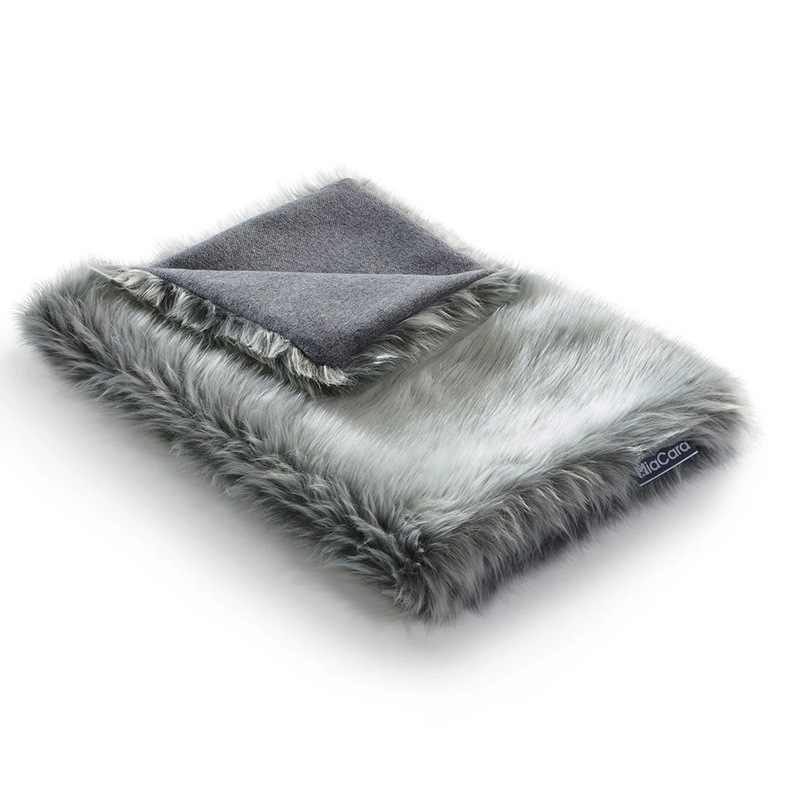Washable cat blanket. Cats love snuggling into and kneading the fluffy sheepskin-like faux fur.