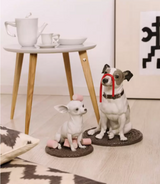 Two Lladro procelain dog figurines on the floor