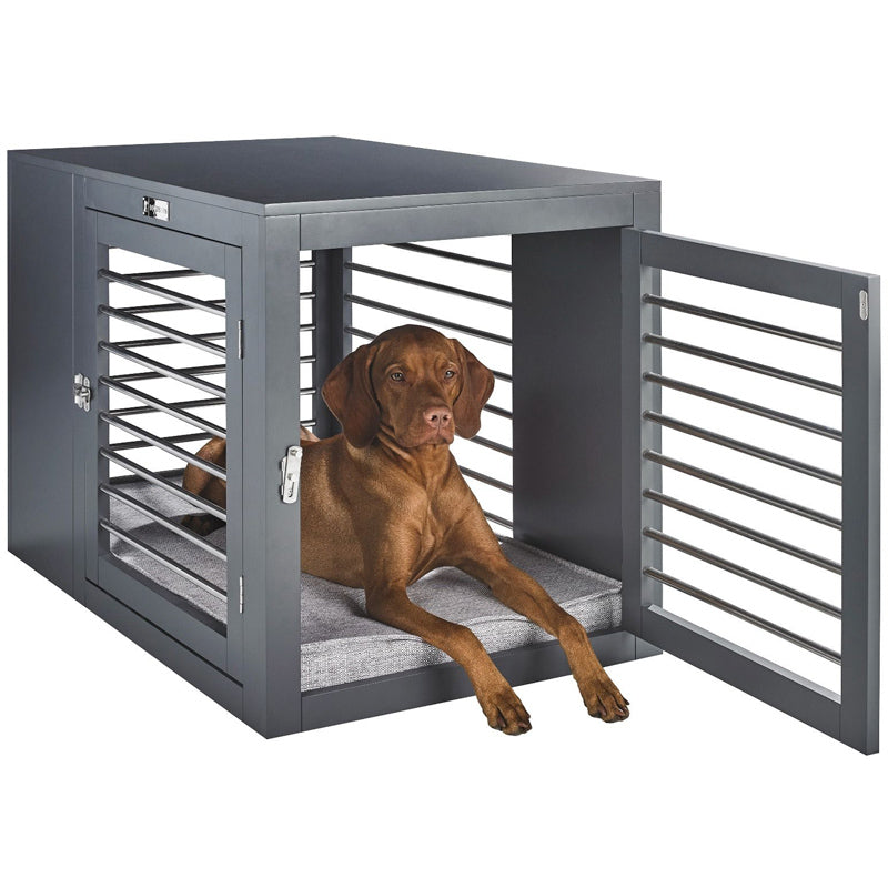 Vizsla ldog sitting in stylish large size dog crate as furniture side table.